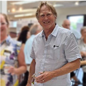 Author J.P. White of Minneapolis, Minnesota is standing in the flooring display area of the showroom at meet and greet held at Excelsior Paint and Design in Excelsior, Minnesota.